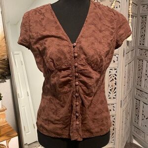 Cute brown embroidered top with button.